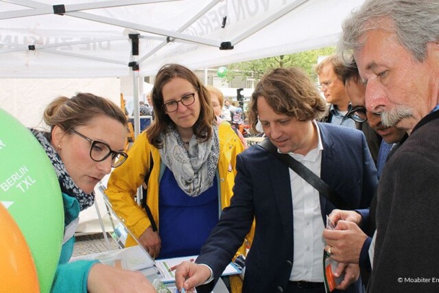 Personen an einem Messestand